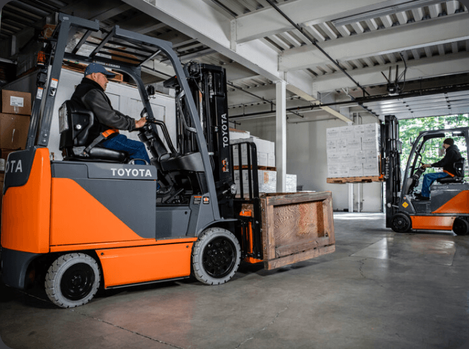 People driving forklifts